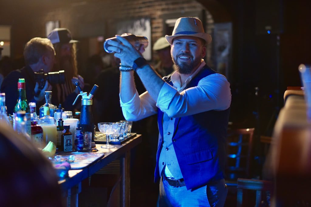 A bartender shaking a cocktail at a King Floyd’s event.